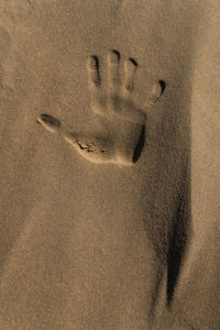 High angle view of footprints on sand