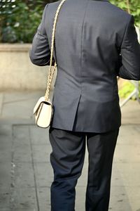 Midsection of man standing on street