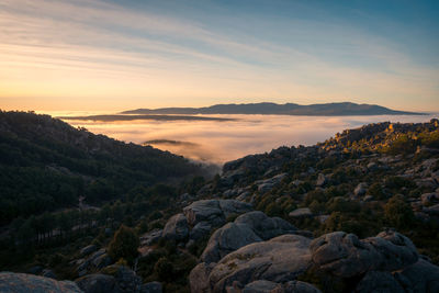 Scenic view of rocky mountains against sky during sunset