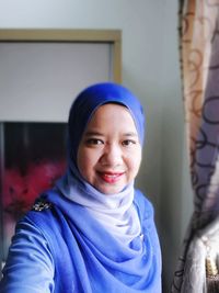 Portrait of smiling woman in blue hijab
