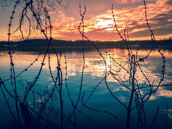 Scenic view of lake against sky at sunset