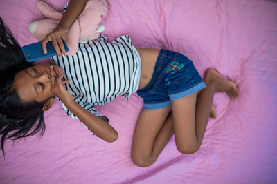 Low angle view of mother and girl on bed