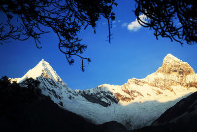 Scenic view of mountains against cloudy sky