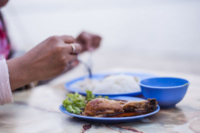 Cropped image of person having food