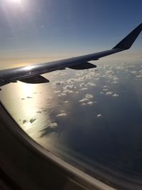 Airplane flying in sky during sunset