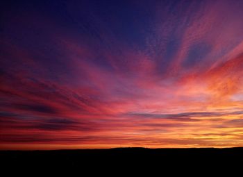 Silhouette landscape against scenic sky