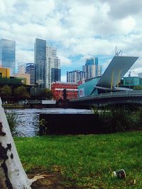 River in city against cloudy sky