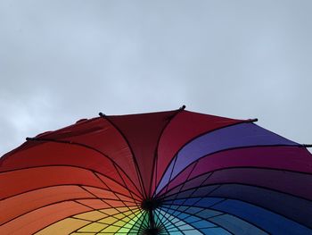 Low angle view of multi colored umbrella against sky, lgbt 