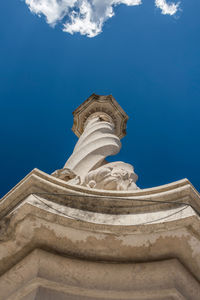 Low angle view of statue against blue sky