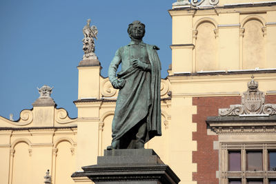 Low angle view of statue against building