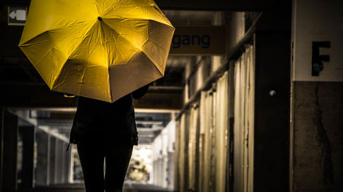 Low section of person walking on wet street during rainy season