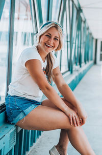 Portrait of smiling young woman sitting outdoors