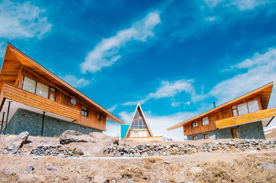 Low angle view of buildings against blue sky