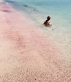 High angle view of boy playing on beach