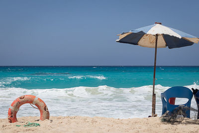 Lifeguard hut on beach against sky