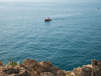 Sailboat on rock by sea