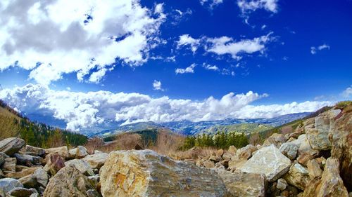 Panoramic view of mountains against blue sky