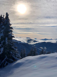 Scenic view of snow covered mountains against sky