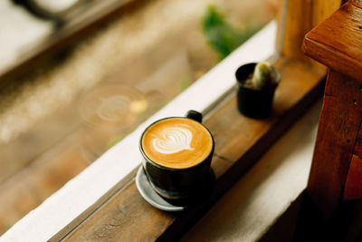 Coffee cup on window sill