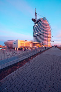 View of buildings in city against clear blue sky