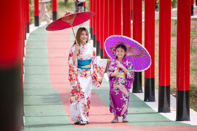 Happy girl holding red umbrella