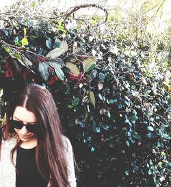 Portrait of young woman wearing sunglasses standing outdoors