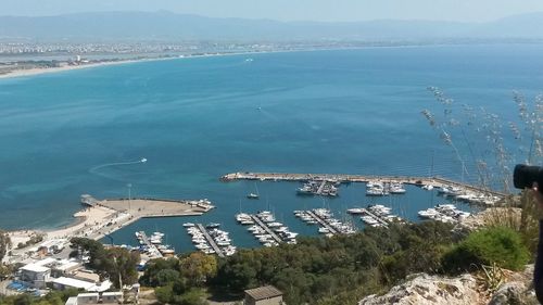 High angle view of town by sea against sky