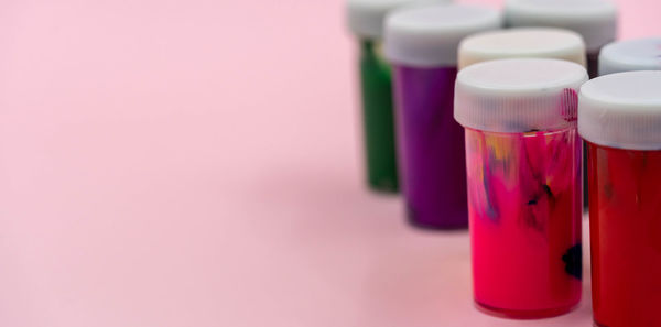 Close-up of pink bottles on table