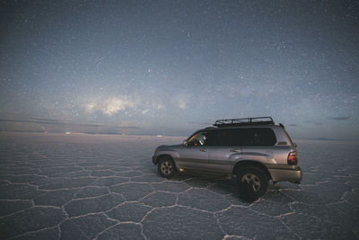 Car under the stars in uyuni salar