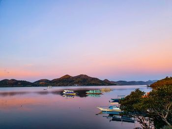 Scenic view of lake against clear sky during sunset