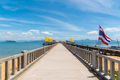 Pathway to the pier on blue sky background.