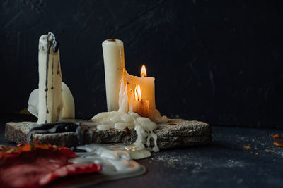 Close-up of lit candles on table