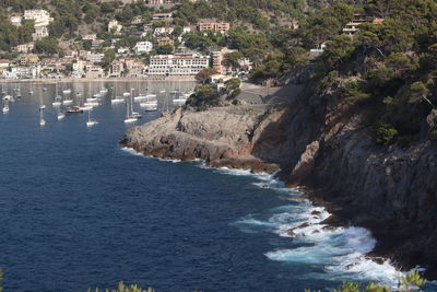 High angle view of sea and buildings in city