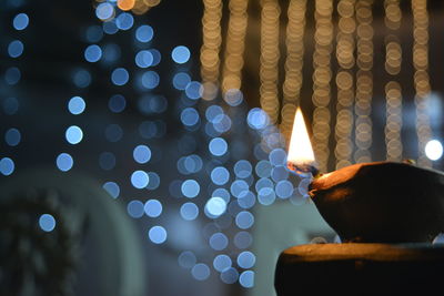 Close-up of hand holding illuminated lighting equipment