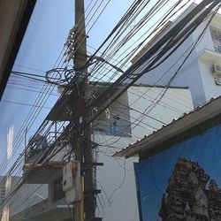 Low angle view of cables against sky