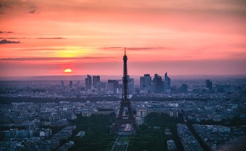 Aerial view of buildings in city during sunset