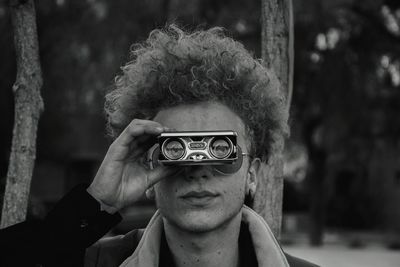 Portrait of man holding camera