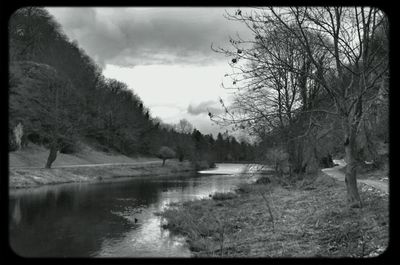 Scenic view of lake against cloudy sky