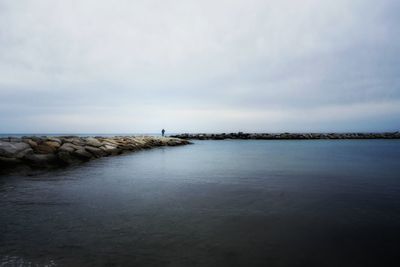 Scenic view of sea against cloudy sky