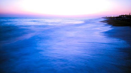 Scenic view of sea against clear sky at sunset