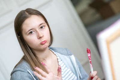 Portrait of girl holding camera