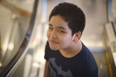 High angle portrait of boy standing on escalator