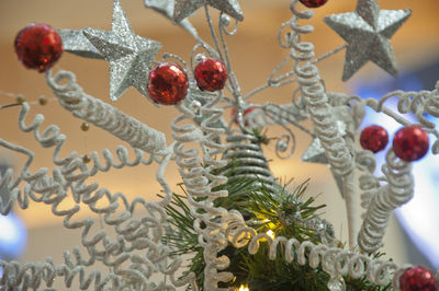 Close-up of christmas decorations hanging on tree