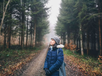 Woman standing in forest