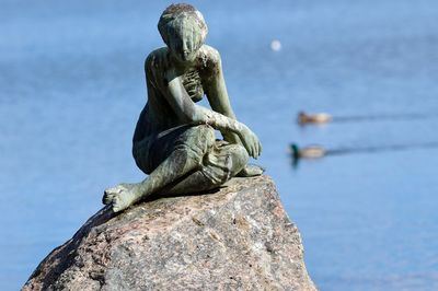 Close-up of statue against blue sky