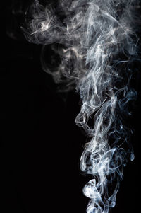 Close-up of cigarette against black background