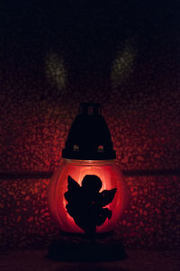 Close-up of illuminated pumpkin against wall at night