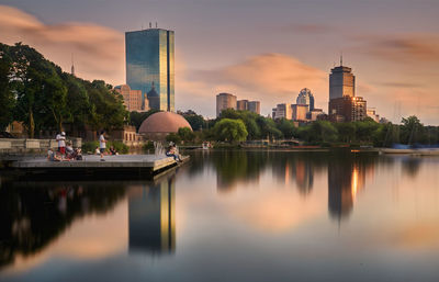 Reflection of buildings in lake at sunset