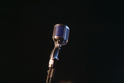 Close-up of light bulb against black background