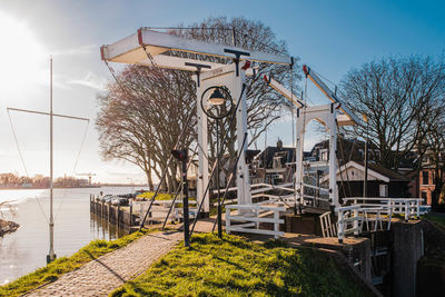 View of bridge by river against sky